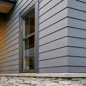 House with gray siding and stone facade