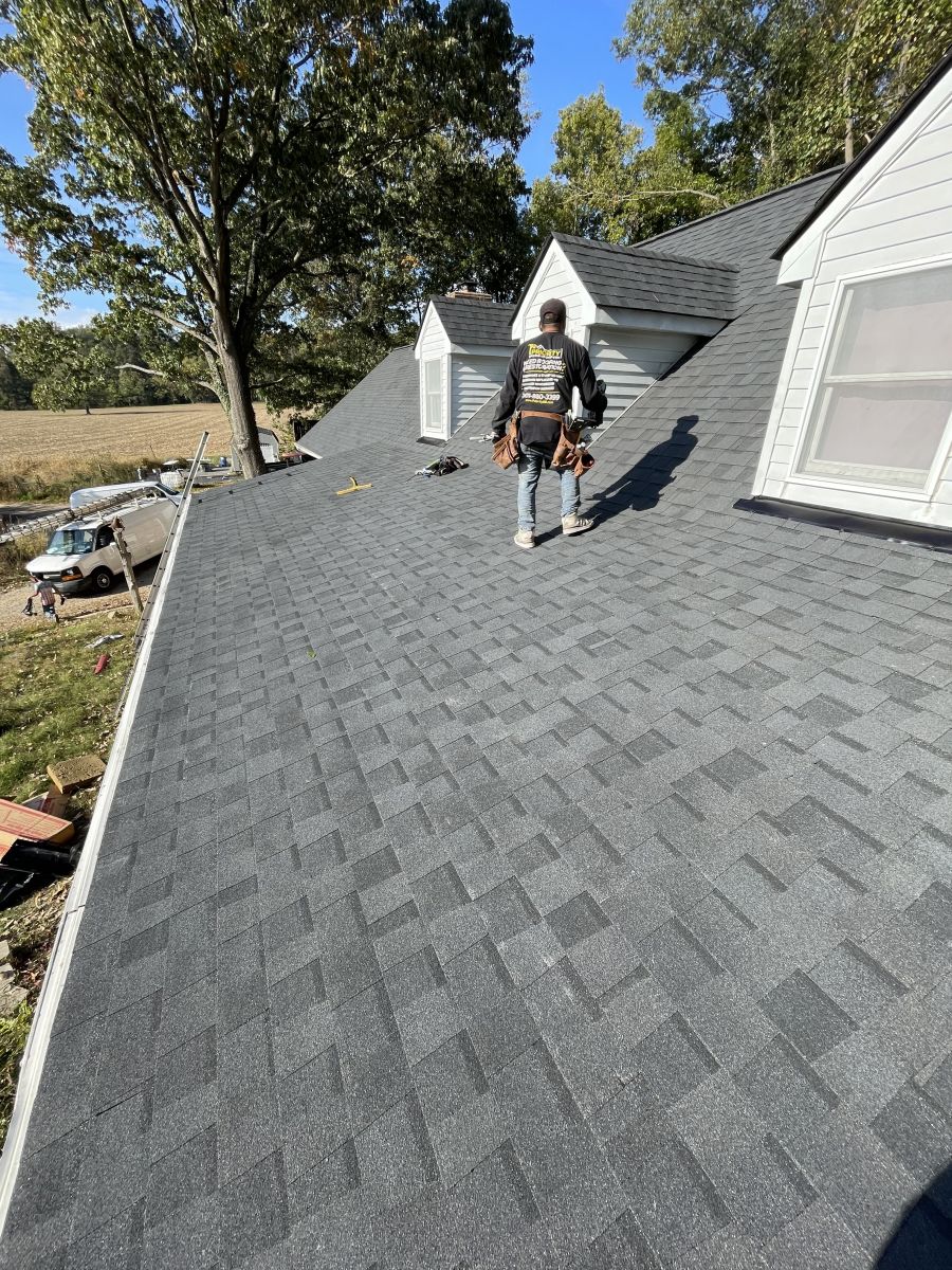 Workers installing a new asphalt roof