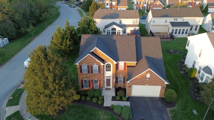 Aerial view of brick home with new asphalt roof 